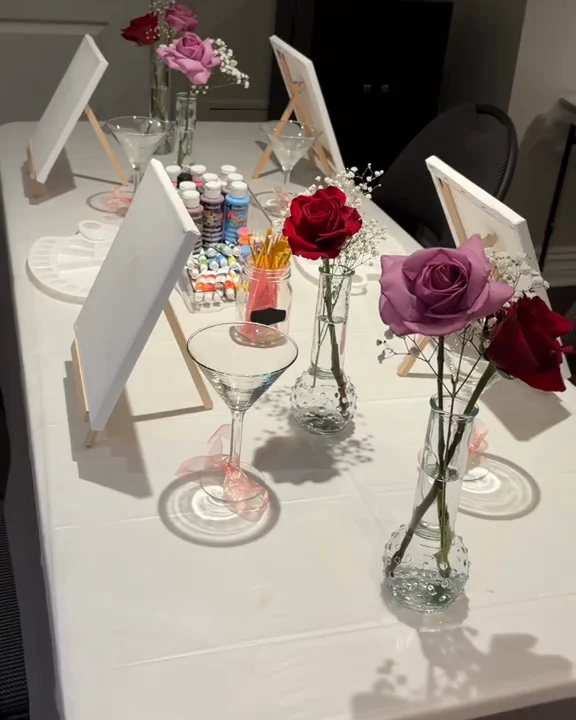 A paint and sip table with roses